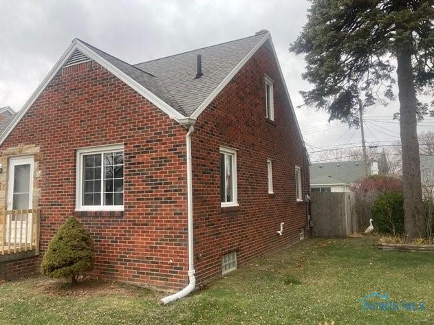 view of side of home with a lawn