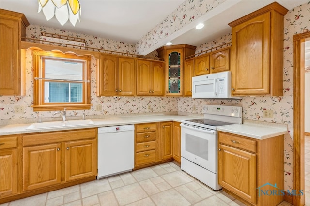 kitchen featuring sink and white appliances