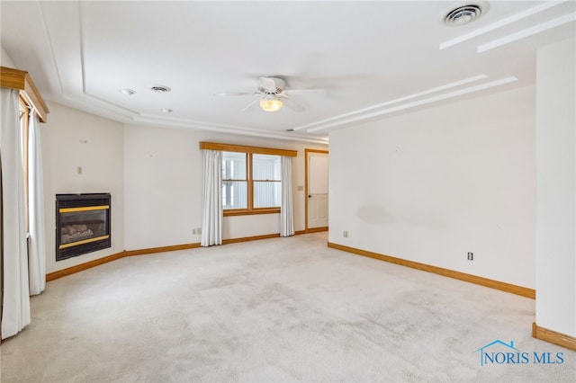 unfurnished living room featuring light carpet and ceiling fan