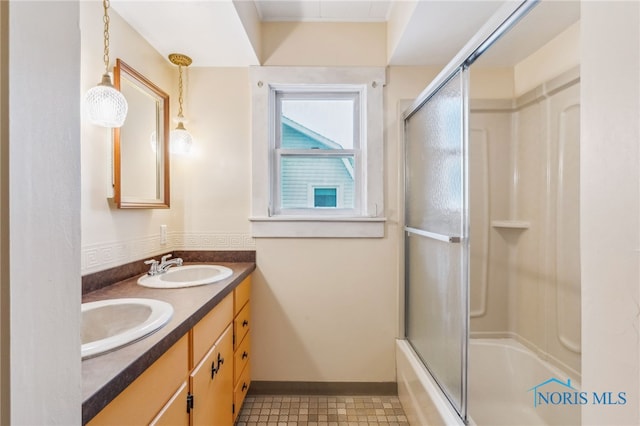 bathroom featuring shower / bath combination with glass door, tile patterned floors, and vanity