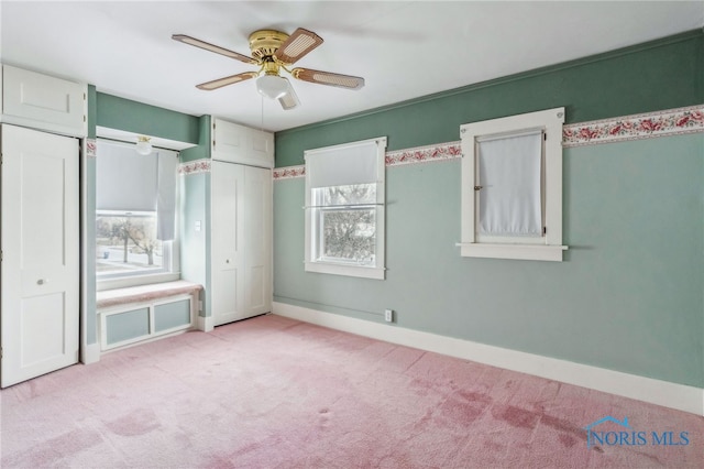 unfurnished bedroom with light colored carpet and ceiling fan