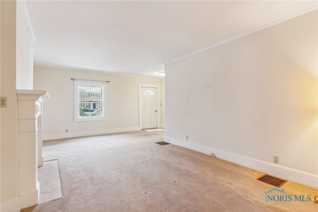 unfurnished living room with crown molding, light colored carpet, and a fireplace