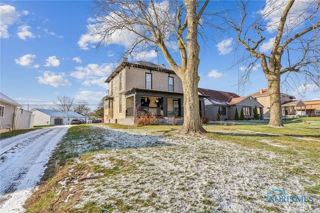 view of front of house with covered porch and a front yard