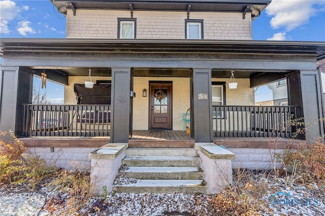 property entrance featuring covered porch