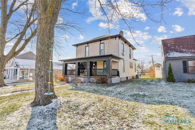 view of front of house with a porch and a front lawn