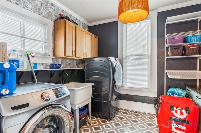 laundry area with cabinets, separate washer and dryer, and crown molding