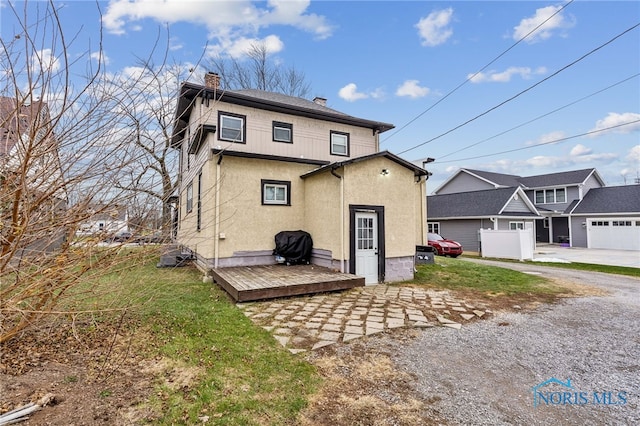 back of property featuring a wooden deck