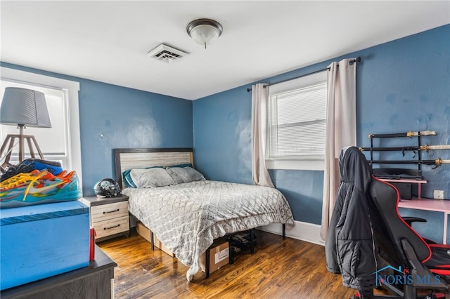 bedroom with dark hardwood / wood-style flooring