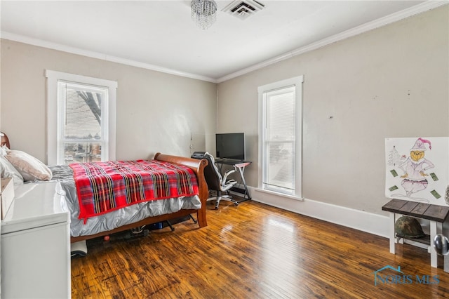 bedroom with hardwood / wood-style flooring, multiple windows, and ornamental molding