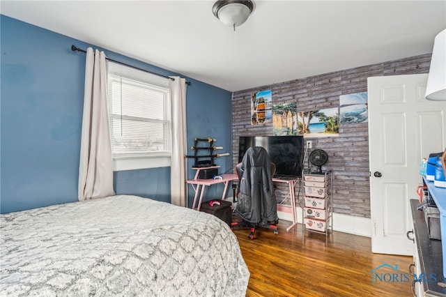 bedroom with dark hardwood / wood-style floors