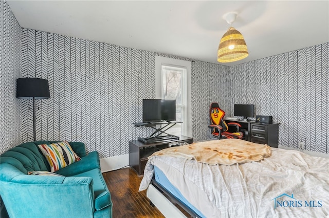 bedroom with dark hardwood / wood-style floors