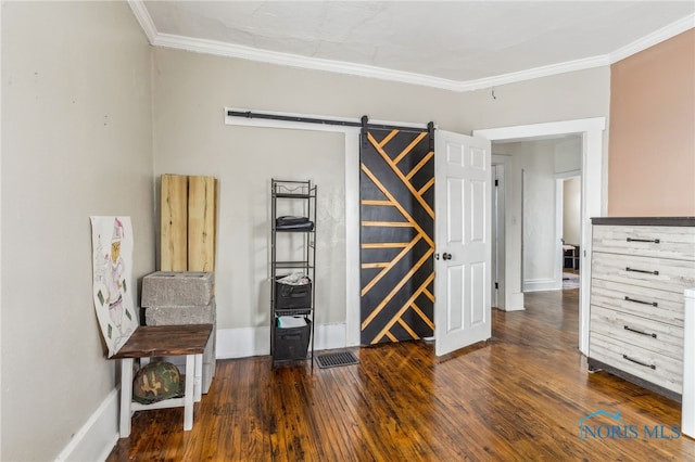 interior space with a barn door, crown molding, and dark hardwood / wood-style flooring