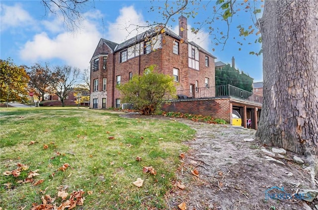 view of side of property with a yard