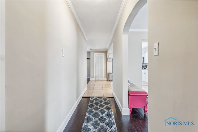 hallway with crown molding and hardwood / wood-style flooring