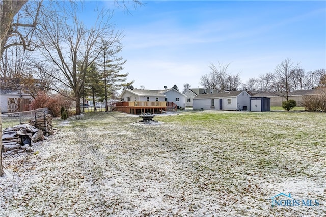 view of yard featuring a storage shed and a wooden deck