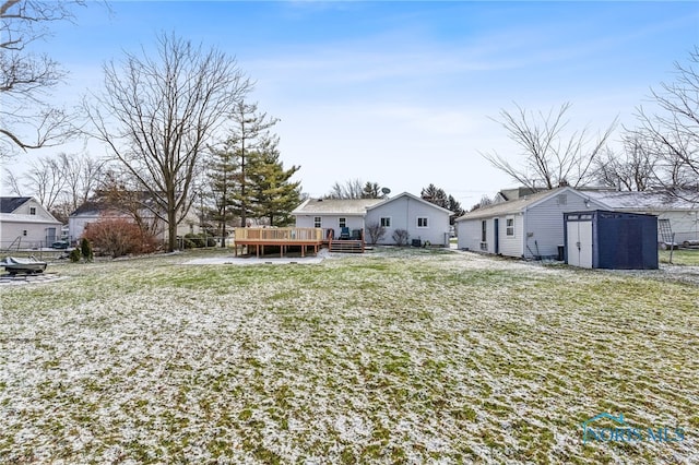 view of yard featuring a storage unit and a deck