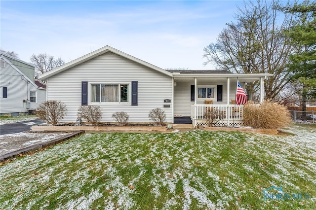 single story home with a porch and a front yard