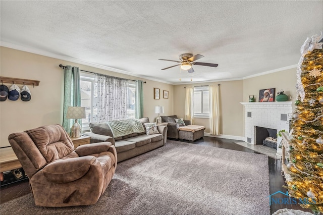 living room featuring a textured ceiling, a brick fireplace, ceiling fan, and ornamental molding