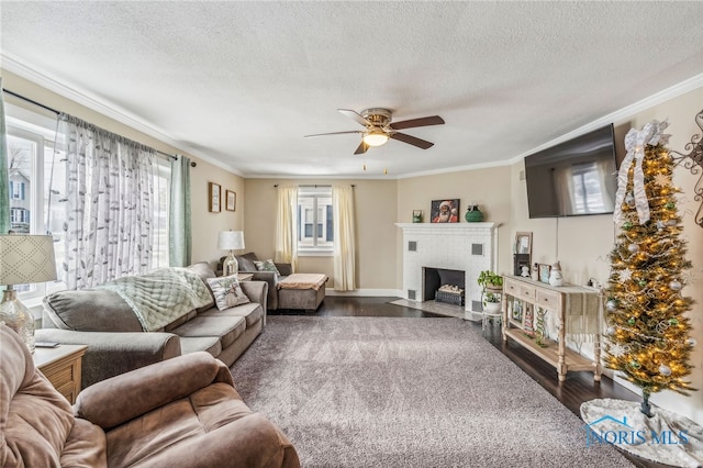 living room with ceiling fan, dark hardwood / wood-style flooring, ornamental molding, and a brick fireplace