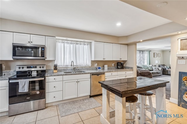 kitchen featuring white cabinetry, sink, and appliances with stainless steel finishes