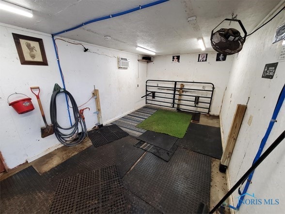 basement with a wall mounted air conditioner