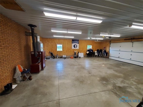 garage featuring wooden walls and a garage door opener