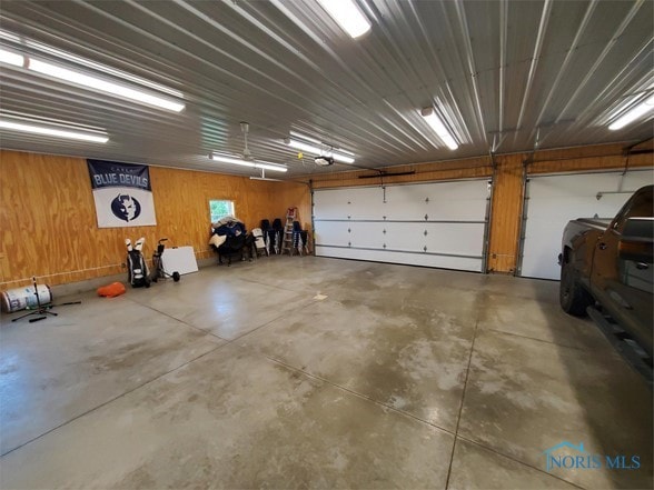 garage featuring wooden walls