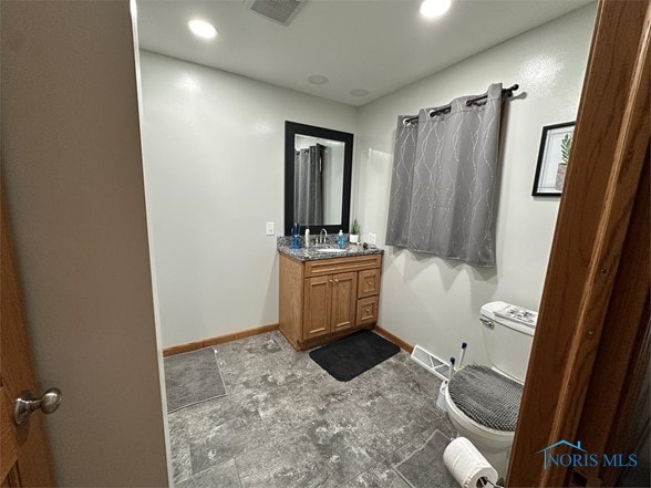 bathroom featuring vanity and toilet