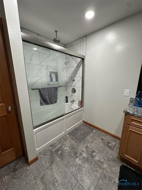 bathroom featuring vanity and enclosed tub / shower combo