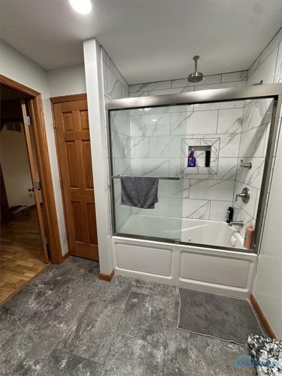 bathroom featuring hardwood / wood-style floors and enclosed tub / shower combo