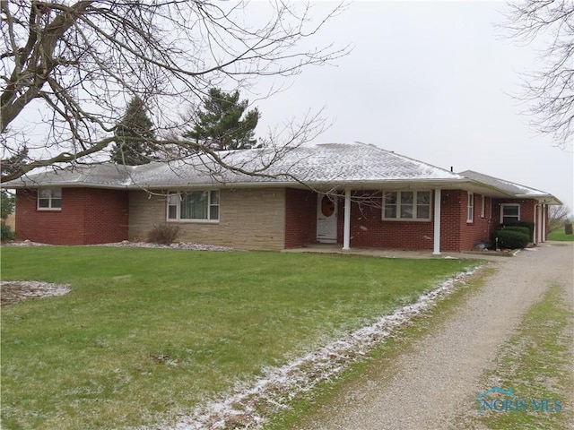 ranch-style house with a front lawn