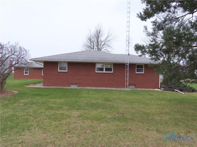 rear view of house with a lawn