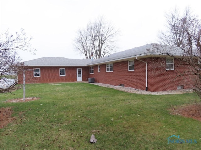 back of house featuring a lawn and central AC unit