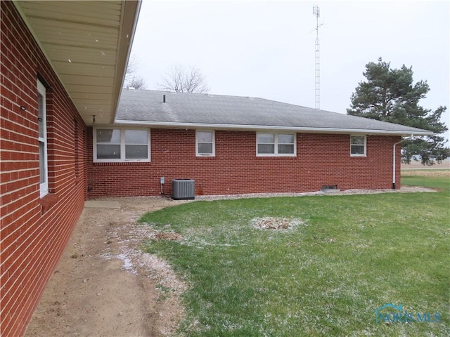 exterior space featuring a lawn and central air condition unit