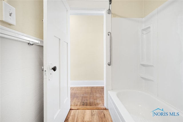 1919 Brookwood Ave, Toledo, OH 43604 - bathroom with hardwood / wood-style flooring, tub / shower combination, and tile walls