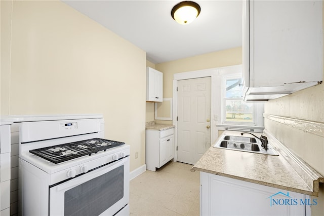 1919 Brookwood Ave, Toledo, OH 43604 - kitchen featuring white cabinets, white gas stove, and sink