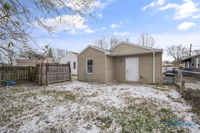 view of snow covered rear of property