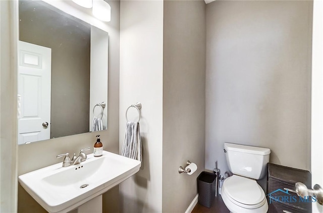 bathroom featuring toilet and sink