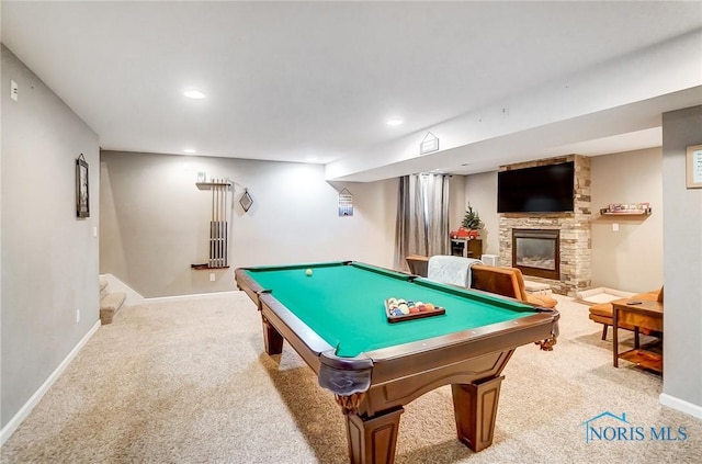 rec room featuring a stone fireplace, light colored carpet, and pool table