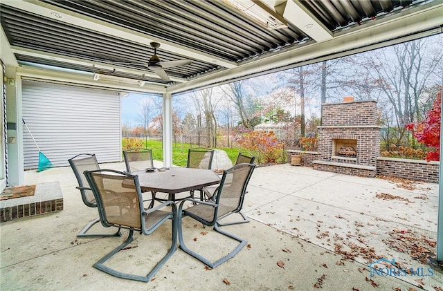 view of patio with ceiling fan and an outdoor brick fireplace