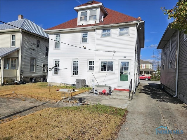 back of house with central air condition unit