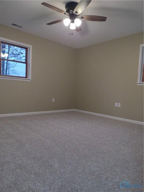 carpeted spare room featuring ceiling fan