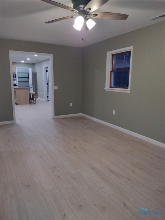 empty room featuring ceiling fan and light wood-type flooring