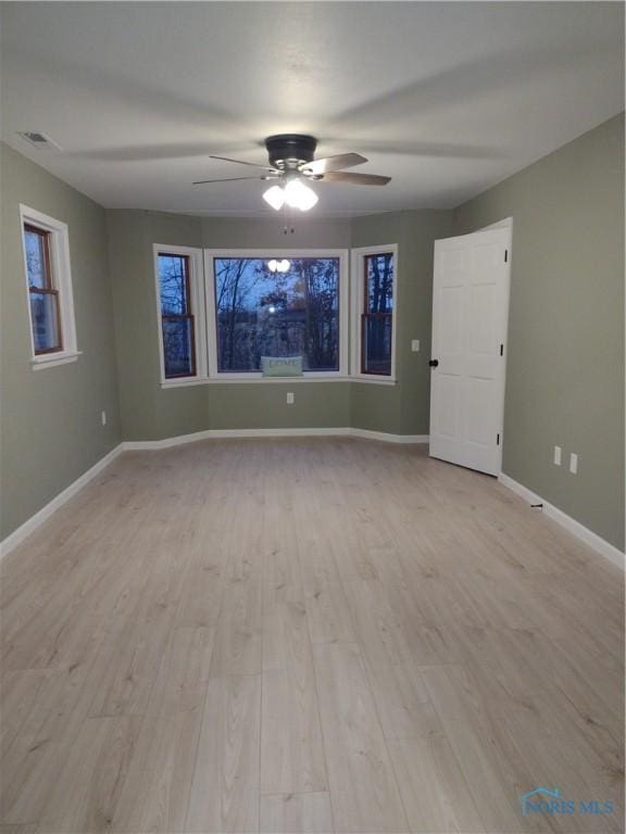 spare room featuring ceiling fan and light hardwood / wood-style flooring