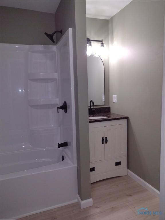 bathroom featuring shower / bathing tub combination, vanity, and wood-type flooring