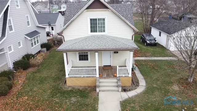 bungalow-style house with covered porch and a front lawn