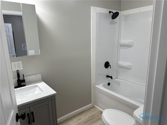 full bathroom featuring wood-type flooring, vanity, toilet, and tub / shower combination