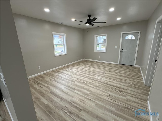 entryway featuring light hardwood / wood-style flooring, ceiling fan, and a healthy amount of sunlight