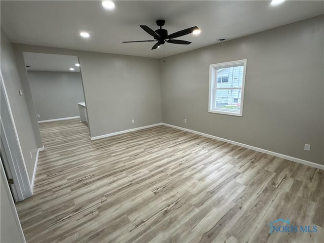 spare room with ceiling fan and light hardwood / wood-style flooring