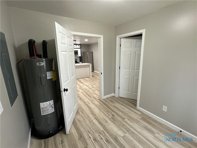 interior space featuring water heater and light hardwood / wood-style floors